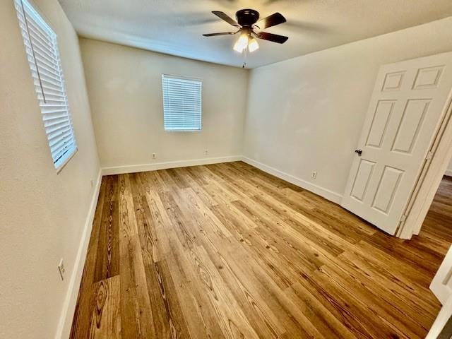 spare room featuring ceiling fan and light hardwood / wood-style floors