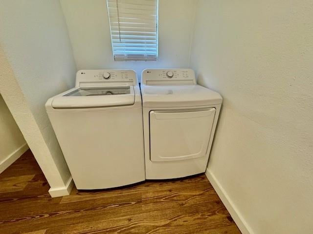 laundry room featuring dark hardwood / wood-style flooring and washer and clothes dryer