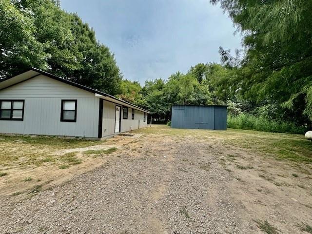 view of side of property with an outbuilding