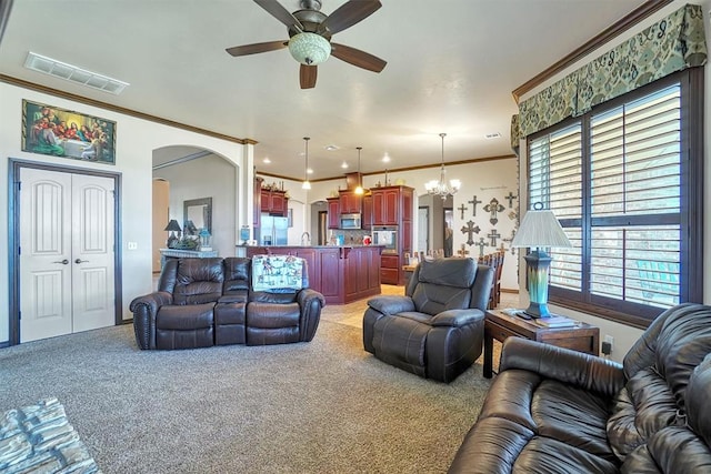 21321 E 1290th Rd, Sentinel, OK 73664 - carpeted living room with crown molding and ceiling fan with notable chandelier