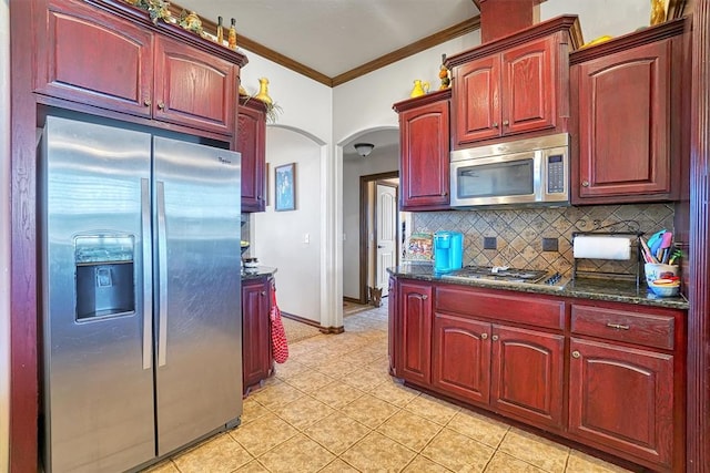21321 E 1290th Rd, Sentinel, OK 73664 - kitchen featuring tasteful backsplash, crown molding, light tile patterned floors, and appliances with stainless steel finishes