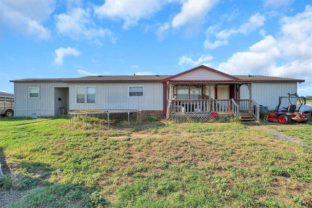 21321 E 1290th Rd, Sentinel, OK 73664 - view of front of property with a porch, a front yard, and a trampoline