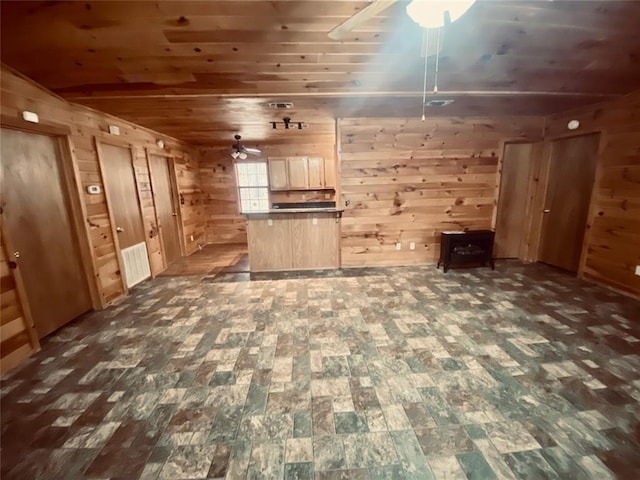 unfurnished living room with wood walls, dark hardwood / wood-style flooring, and wooden ceiling