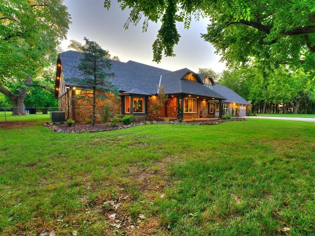 view of front of property with a yard and cooling unit