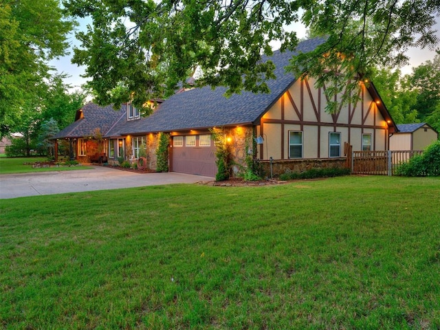 view of front of property with a front yard and a garage