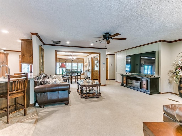 carpeted living room featuring a textured ceiling, ceiling fan with notable chandelier, ornamental molding, and sink