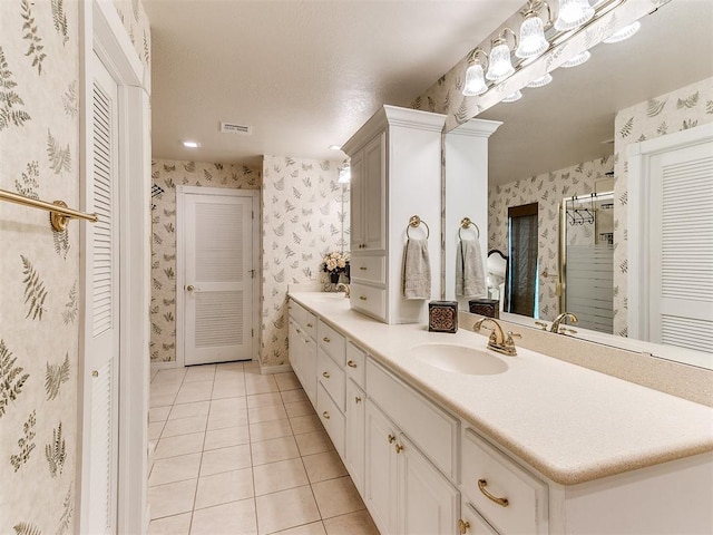 bathroom featuring tile patterned flooring, vanity, and an enclosed shower