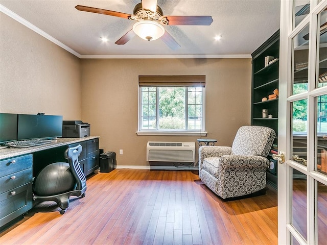 office space featuring ceiling fan, a wall mounted AC, wood-type flooring, a textured ceiling, and ornamental molding