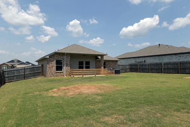 back of property featuring a yard and cooling unit