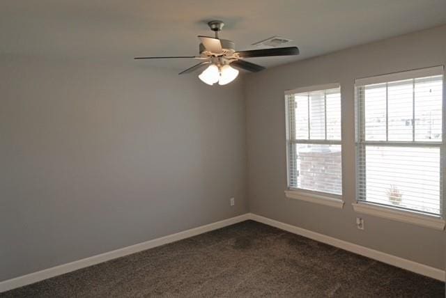 carpeted spare room with ceiling fan