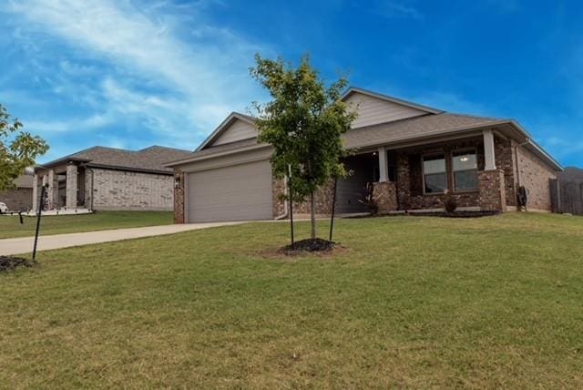 view of front of property with a front yard and a garage