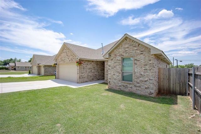 ranch-style house with concrete driveway, brick siding, fence, and a front lawn