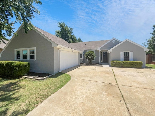 ranch-style home featuring a garage and a front lawn