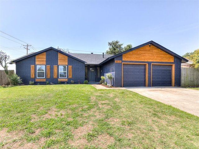 single story home with a front yard and a garage