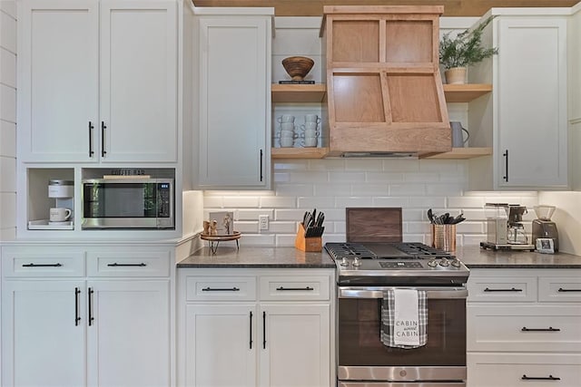 kitchen with white cabinets, decorative backsplash, and stainless steel appliances