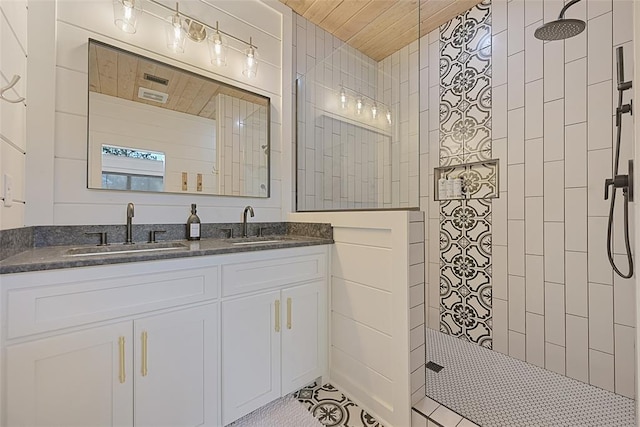 bathroom featuring tile patterned floors, vanity, a tile shower, and wooden ceiling