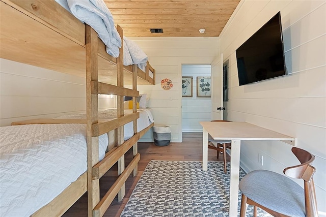 bedroom with dark hardwood / wood-style floors, wood walls, and wood ceiling