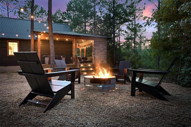 patio terrace at dusk featuring a fire pit