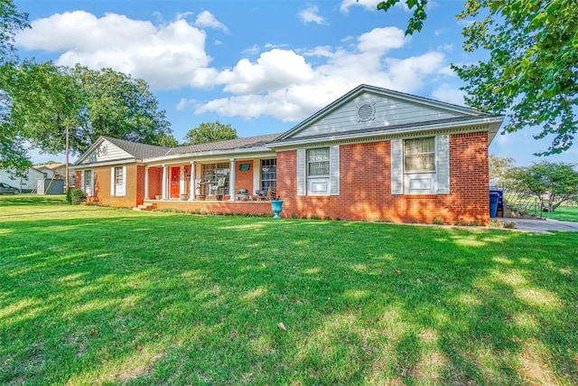 ranch-style house with covered porch and a front lawn