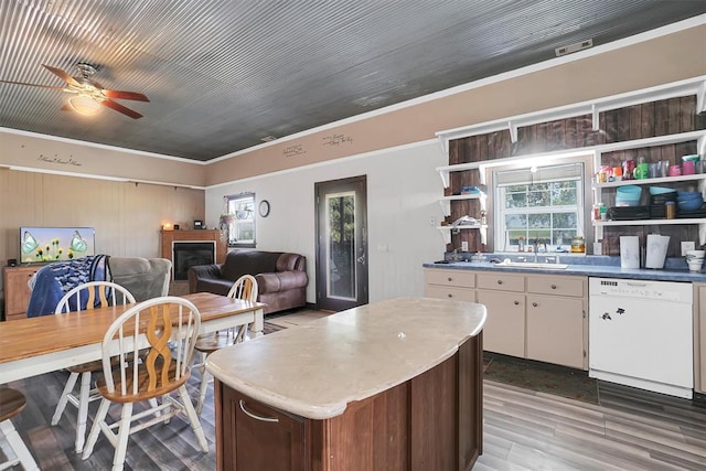 kitchen with ceiling fan, sink, crown molding, white dishwasher, and wood-type flooring