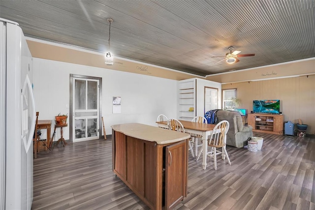 kitchen featuring ceiling fan, dark hardwood / wood-style floors, white refrigerator with ice dispenser, and hanging light fixtures