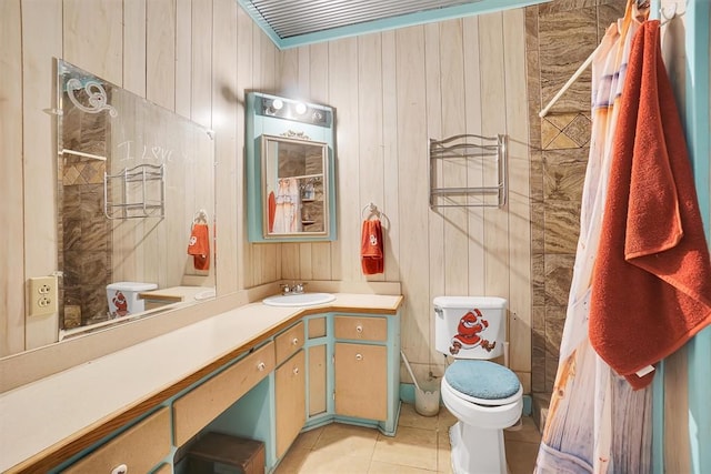 bathroom with tile patterned floors, vanity, wood walls, and toilet