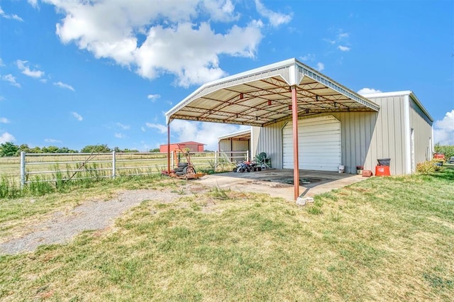 view of yard with a garage, an outdoor structure, and a carport