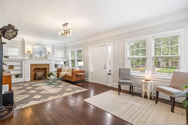 living room with crown molding, plenty of natural light, hardwood / wood-style floors, and an inviting chandelier