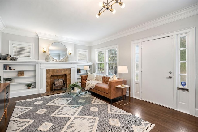 living room with a notable chandelier, dark hardwood / wood-style floors, and ornamental molding