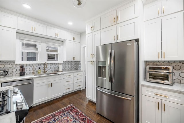 kitchen featuring dark hardwood / wood-style floors, white cabinetry, sink, and appliances with stainless steel finishes