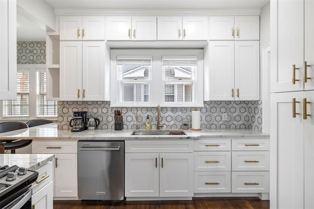 kitchen featuring white cabinets, appliances with stainless steel finishes, a wealth of natural light, and sink