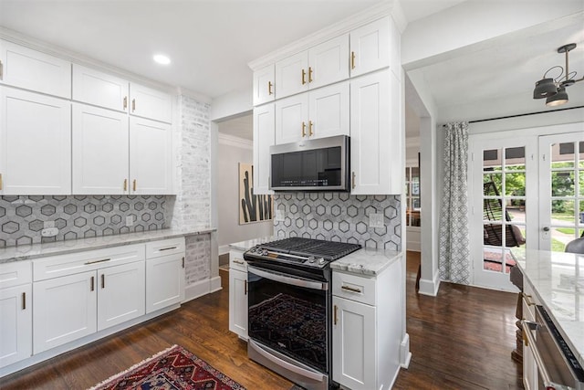 kitchen featuring white cabinets, decorative backsplash, stainless steel appliances, and dark wood-type flooring