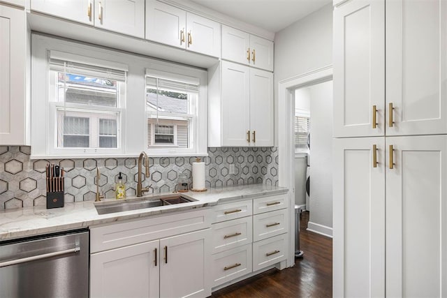 kitchen featuring light stone countertops, stainless steel dishwasher, dark wood-type flooring, sink, and white cabinetry