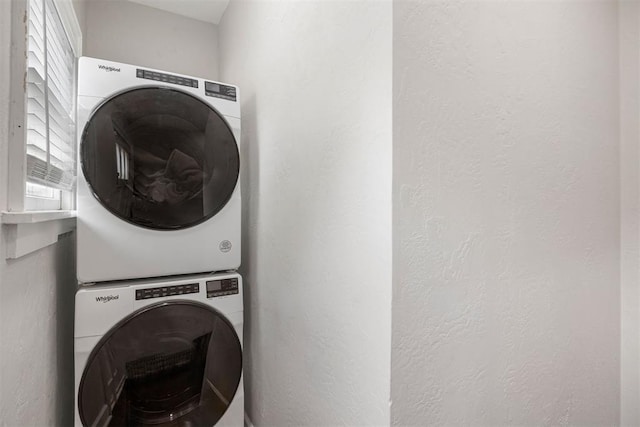 laundry room with stacked washing maching and dryer