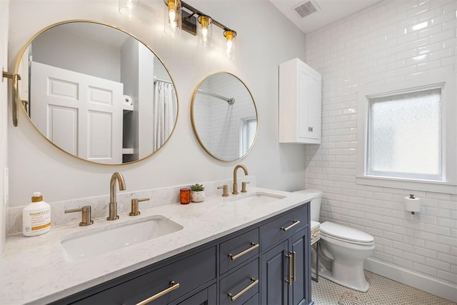 bathroom featuring tile patterned flooring, vanity, and toilet