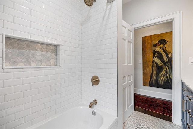 bathroom featuring tile patterned flooring, vanity, and tiled shower / bath combo