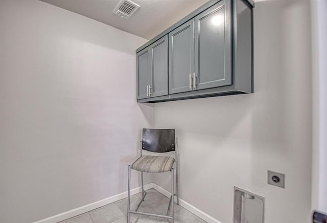 laundry room featuring hookup for an electric dryer and cabinets