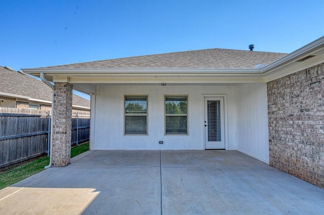 view of exterior entry with a patio