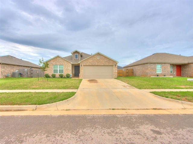 single story home with a front yard, a garage, and central AC unit