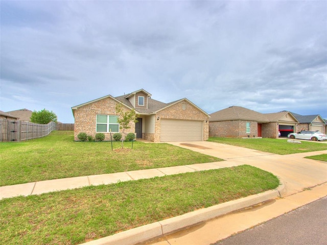 view of front of home with a front yard and a garage