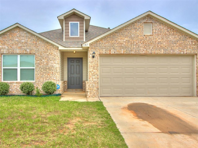 view of front facade with a front yard and a garage