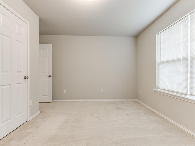 empty room featuring light colored carpet