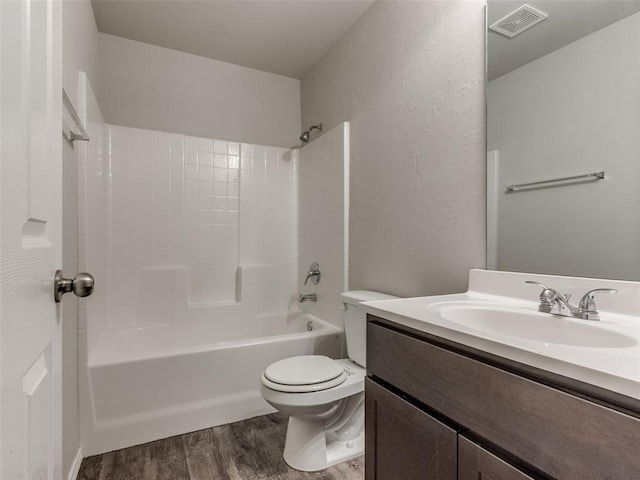 full bathroom with vanity,  shower combination, hardwood / wood-style flooring, and toilet