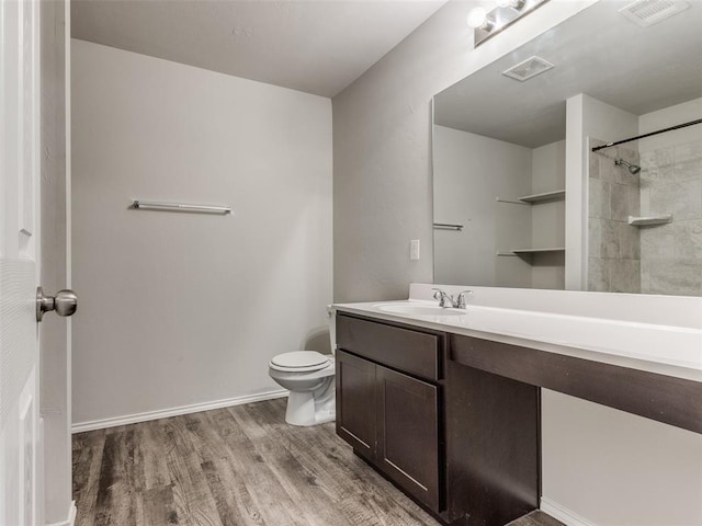 bathroom featuring vanity, toilet, and wood-type flooring