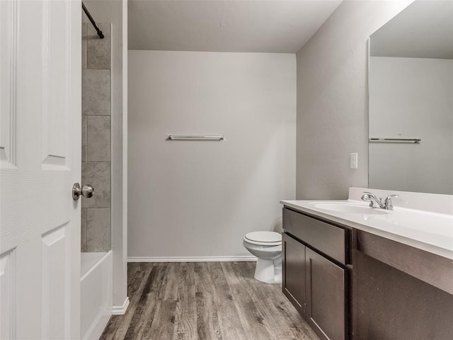 full bathroom with wood-type flooring, vanity, toilet, and tiled shower / bath combo