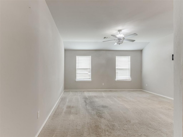 empty room featuring light carpet and ceiling fan