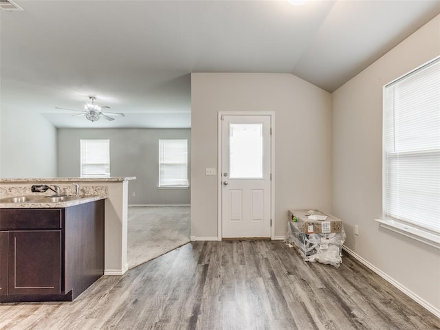 foyer with light wood-type flooring, ceiling fan, lofted ceiling, and sink