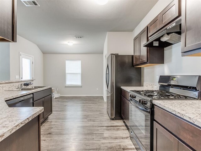 kitchen featuring dark brown cabinetry, sink, light hardwood / wood-style flooring, range hood, and appliances with stainless steel finishes