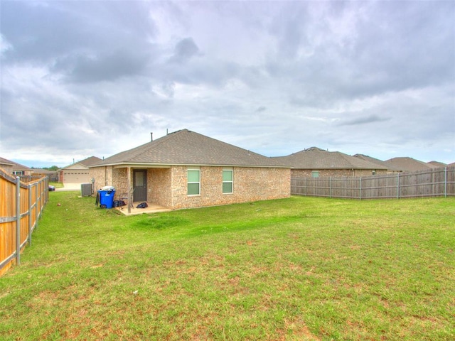 back of house with a lawn