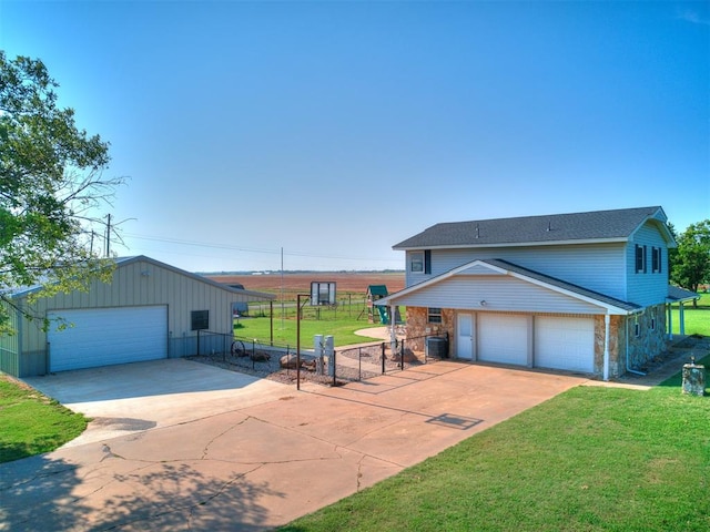 view of front facade featuring a front yard, a garage, and cooling unit